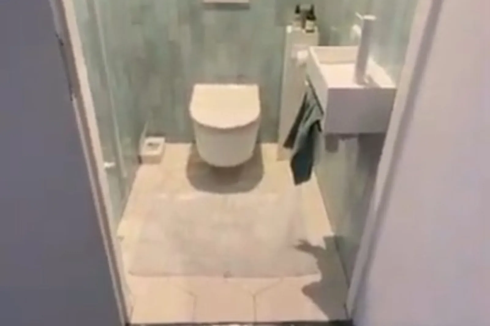 Glaze Soft — compact aqua powder room from the doorway