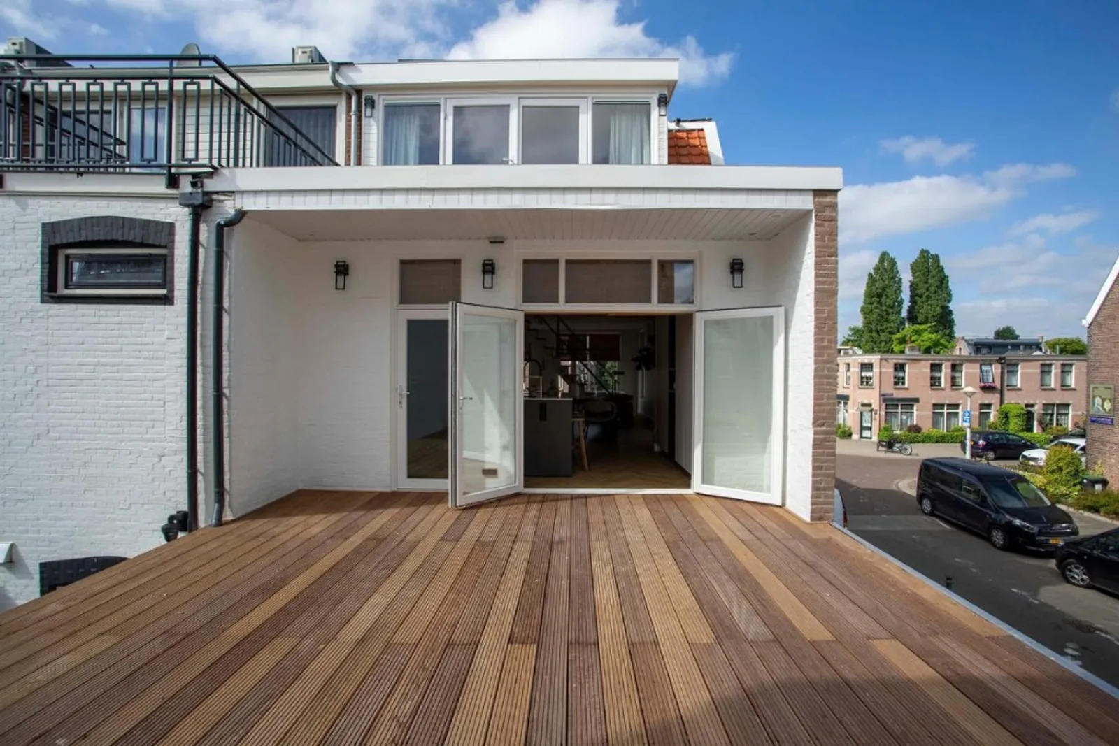 Warm Terrace — rooftop terrace and white brick facade