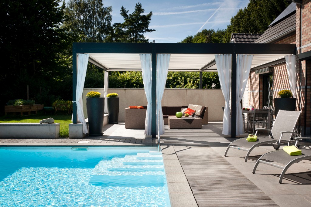 Bioclimatic pergola beside a pool terrace